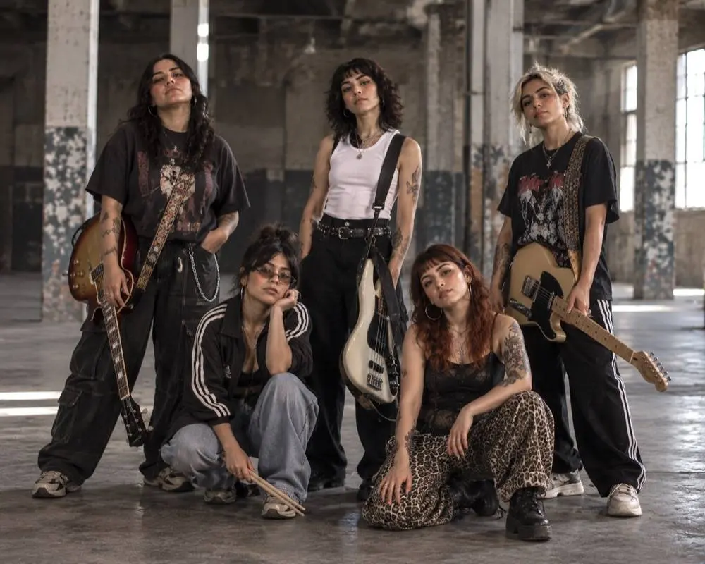 Banda de rock retratada en una nave industrial